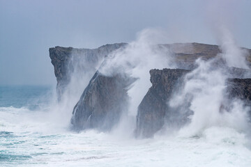 Landscape of the karst limestone sea cliffs in Asturias in the Llanes coast, North of Spain, with the waves cruhsing against the cliffs.