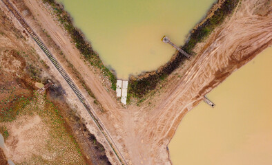Top view of sand quarry mining with pond
