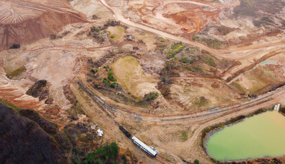 Top view of sand quarry mining with pond