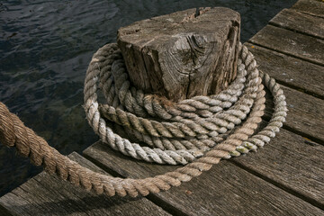 Fototapeta na wymiar curled coir rope with wooden pier