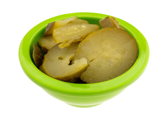 Small green bowl filled with cucumber salad isolated on a white background.