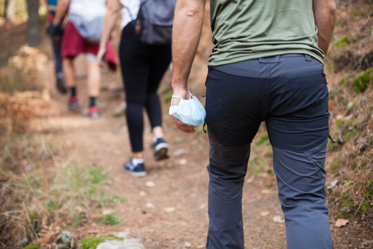 Group of friends hiking in the mountains during covid-19 times