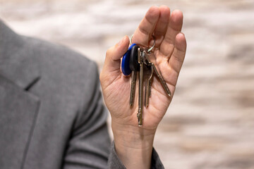 House key in womans hands, concept of moving or rent appartment. Business concept.