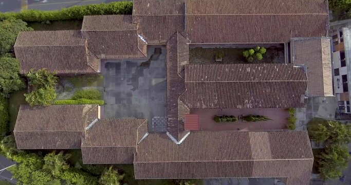Large Colonial House Rooftops with Lots of Trees Around on a Cloudy Day
