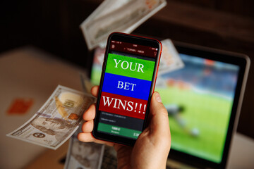 Smartphone with gambling mobile application and money.