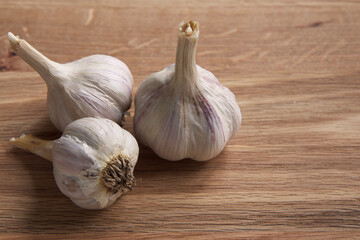 Whole garlic on the wooden background.