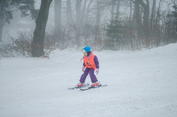 child having sport activity of skiing in winter woodland