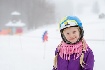 child having sport activity of skiing in winter woodland