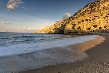 Stunning Roman catacombs carved on the sandstone cliffs above the Matala Beach, Crete, Greece. In Roman times, the dead were buried in them, later they were used by the first Christians