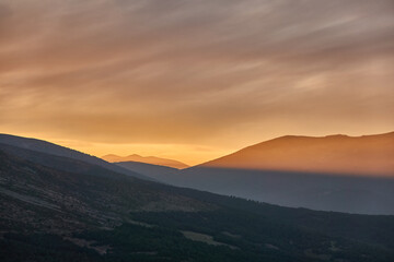Obraz na płótnie Canvas Sunset over Pico de Peñalara and the Lozoya Valley from Puerto de la Morcuera in the Sierra de Guadarrama National Park. Madrid's community. Spain