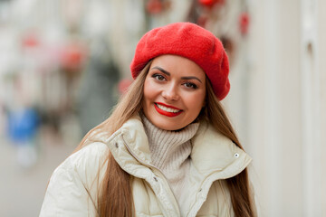 Street style portrait of young beautiful fashion woman walking in europian city on winter holidays. Stylish model in casual clothes with long hair doing new year shopping. 