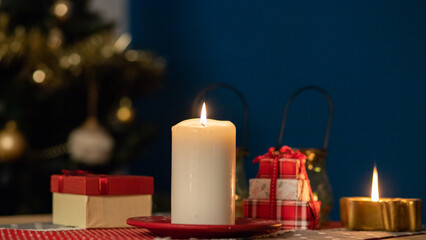 candle burning on Christmas table