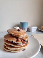 Breakfast: fluffy pancakes with chocolate and butter