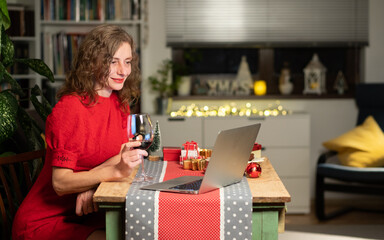 woman spending Christmas eve at home with laptop