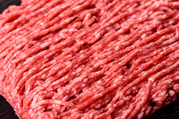 Fresh raw beef mince on a dark background