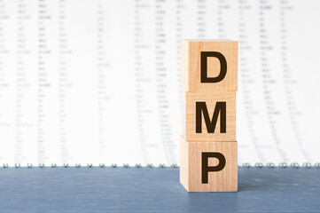 DMP Debt Management Plan acronym on wooden cubes on grey backround. Business concept.