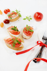 Caprese and Toast bruschetta with mozzarella cheese, cherry tomatoes and fresh garden basil. Traditional Italian food, healthy natural breakfast, cholesterol and GMO free, space for text,