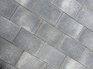 Grey brick wall texture background. Tiled.