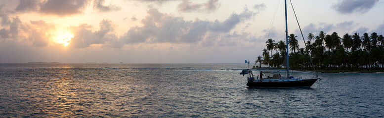 Sailing with beautiful sunset near paradise island, San Blas