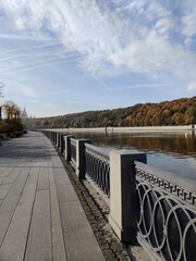 Naklejka premium Luzhnetskaya embankment in Moscow. View of autumn trees and Stalin's skyscraper