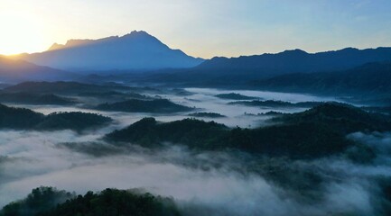 Fototapeta na wymiar Beautiful Landscape of misty foggy with mount kinabalu during sunrise
