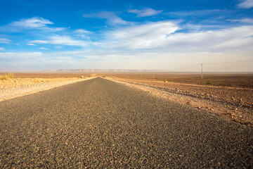 Fototapeta na wymiar Straight desert road in Morocco, Africa