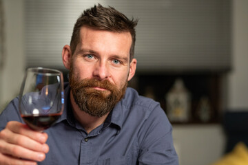 portrait of handsome man spending Christmas eve at home with laptop