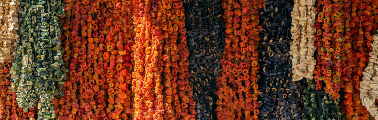 Dried vegetables in the Traditional Bazaar at Malatya City, Turkey. Dry raw red peppers, eggplants and okra are hanging in front of the market,