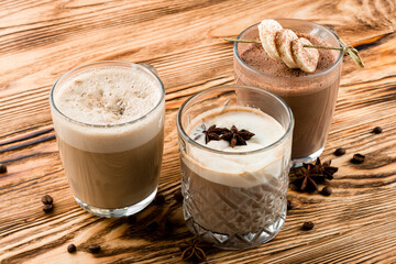 set of warm drinks on a wooden table, cocoa, hot chocolate and Glasse coffee