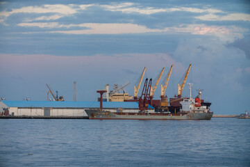 Fototapeta premium Tripoli, Libya - November 25, 2020: Container ships with loading cranes in the Port of Tripoli