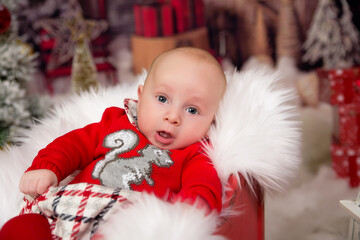 Amazed attractive baby boy in Christmas costume crawling