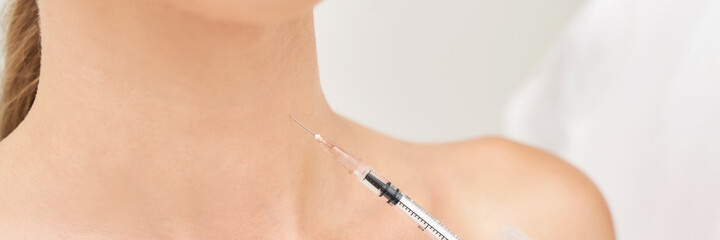 Neck injection at spa salon. Doctor hands. Closeup view. High quality. Pretty female patient....