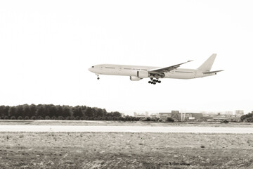 Fototapeta na wymiar Plane landing to Airport. Black and white. No trademark on.