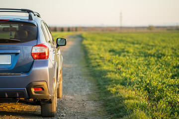 Landscape with blue off road car on gravel road. Traveling by auto, adventure in wildlife,...