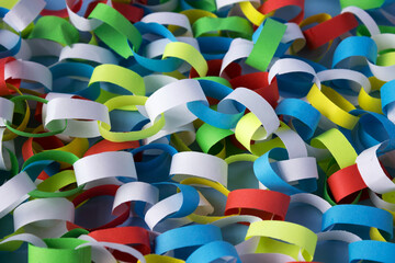 Garland of colorful paper, festive background. Self-made rings from white, red, yellow and green paper.