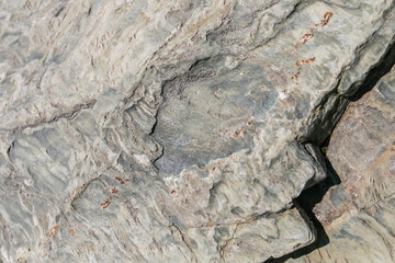 Rough gray flat granite wall cliff mountain, crack grey stone hill texture, fracture hard rock...