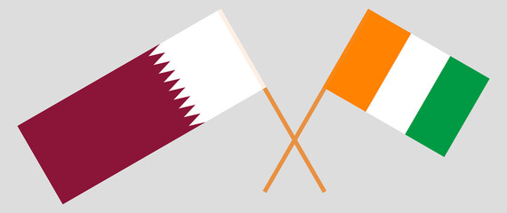 Fototapeta na wymiar Crossed flags of Qatar and Republic of Ivory Coast