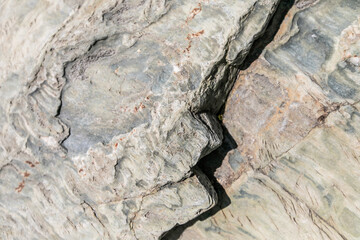 Rough gray flat granite wall cliff mountain, crack grey stone hill texture, fracture hard rock...