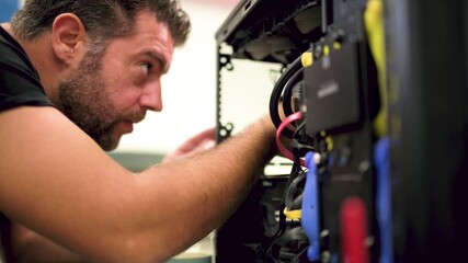White man assembling his own computer himself at home close up