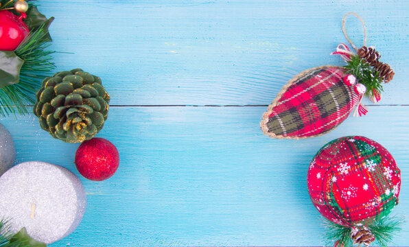 christmas decorations on blue wood; Shot of cones, Christmas balls and tree decorations from above