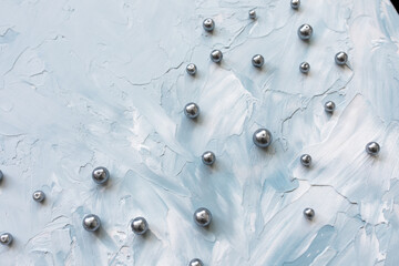 Black pearls on blue creative abstract backround. Winter, Christmas, New Year celebration, woman lifestyle concept. Flat lay, top view, copy space