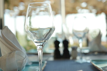 Empty wine glass and copy space. Blurred cafe interior background.