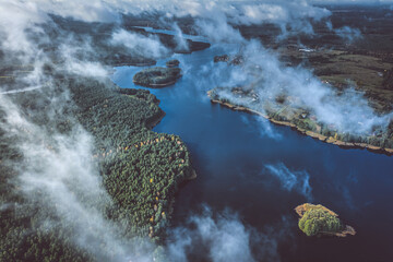 Aerial view of lake and clouds below