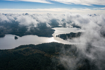 Aerial view of lake and clouds below