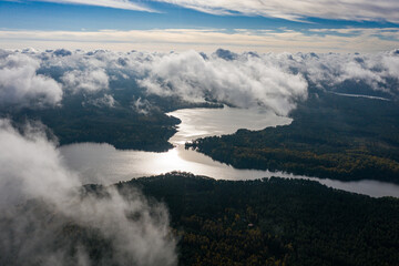 Aerial view of lake and clouds below