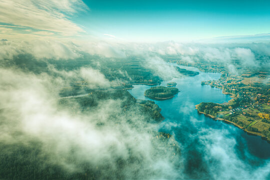 Aerial view of lake and clouds below