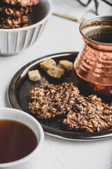 Banana oatmeal cookies with chocolate spread with turkish coffee on metal tray