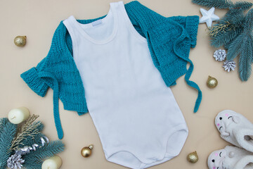White children's T-shirt with a sweater on a colored background with Christmas decorations. Layout...