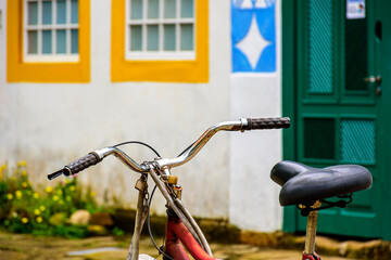 Fototapeta na wymiar Old bicycle stopped in front of the colonial style houses of the historic city of Paraty on the south coast of Rio de Janeiro