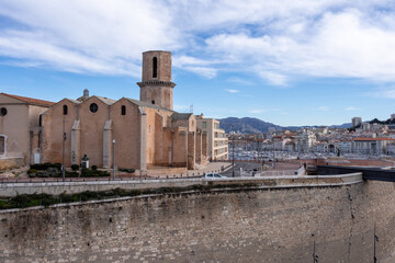 Cityscape in Marseille. A city located on the Mediterranean coast near the mouth of the Rhône. Some clouds in the sky. View on an old building.